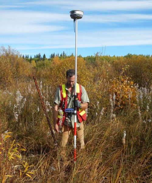 bench-mark-man-holding-rtk-system