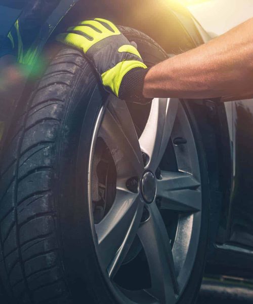 Flat Tire Replacing Closeup Photo. New Tire For the Modern Vehicle.