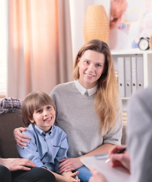 Smiling son with parents during consultation with advisor